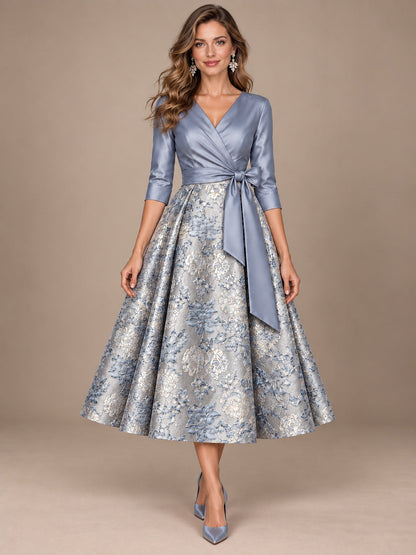 Dusty blue floral jacquard mother of the bride midi dress with V-neck, 3/4 sleeves and tie waist